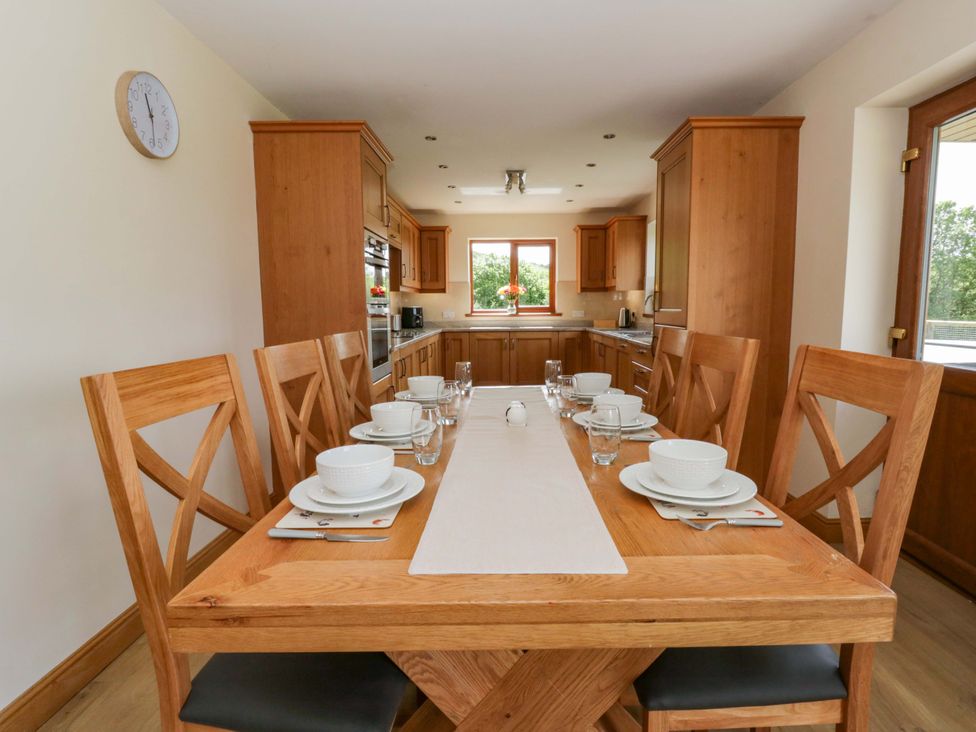 A dining room with a wooden table set for a meal at Yr Onnen 
