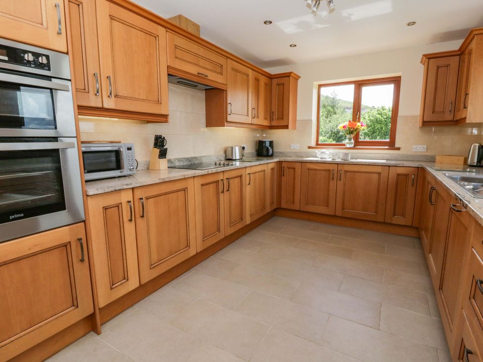 A kitchen with cabinets and appliances at Yr Onnen in 