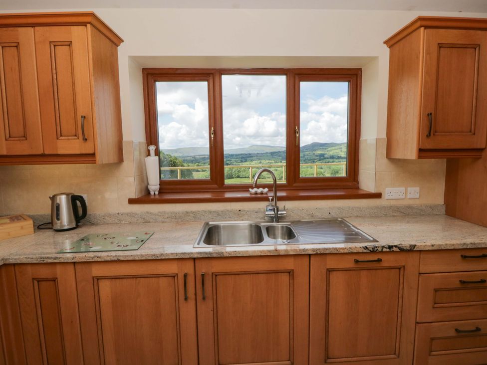 A kitchen with a sink and window at Yr Onnen