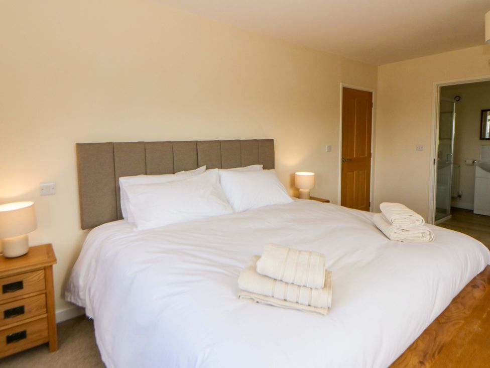 A bedroom with a large bed and towels on it at Yr Onnen