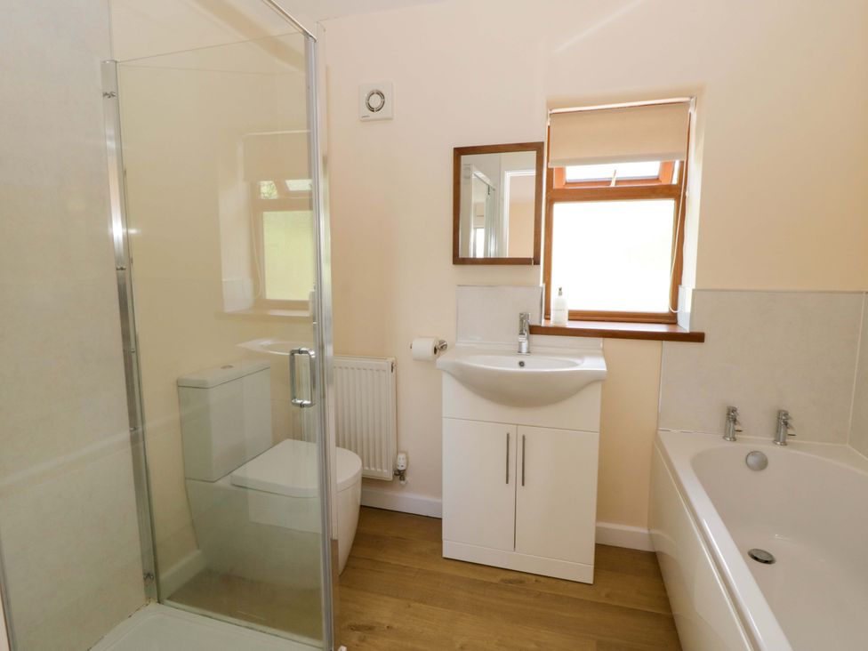 A bathroom with a shower, sink, toilet and bathtub at Yr Onnen