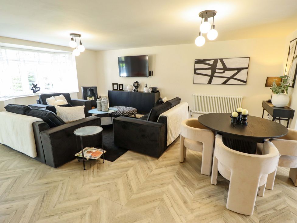 A living room with a sofa, television, and dining table at 21 Anderby road 