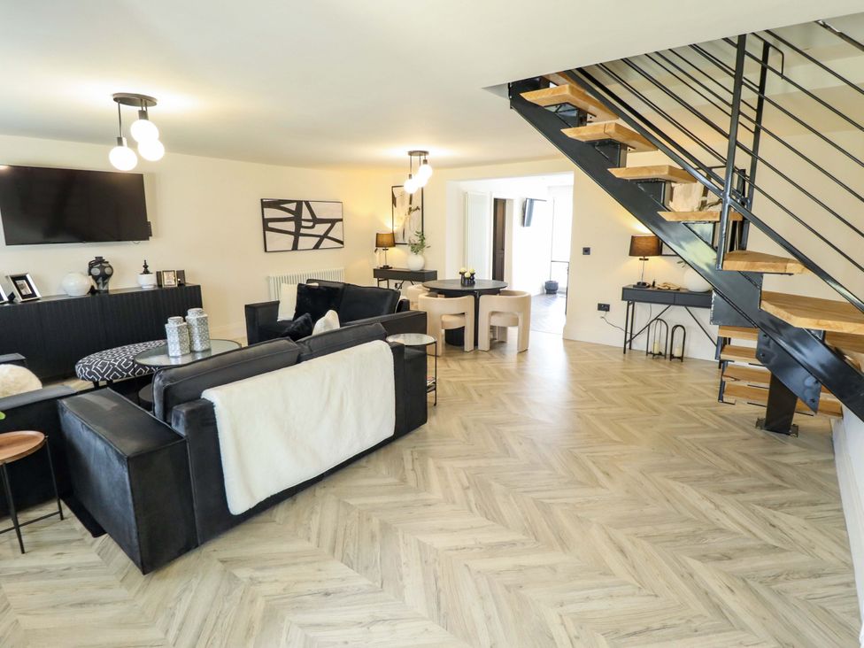 A living room with a sofa and staircase at 21 Anderby road