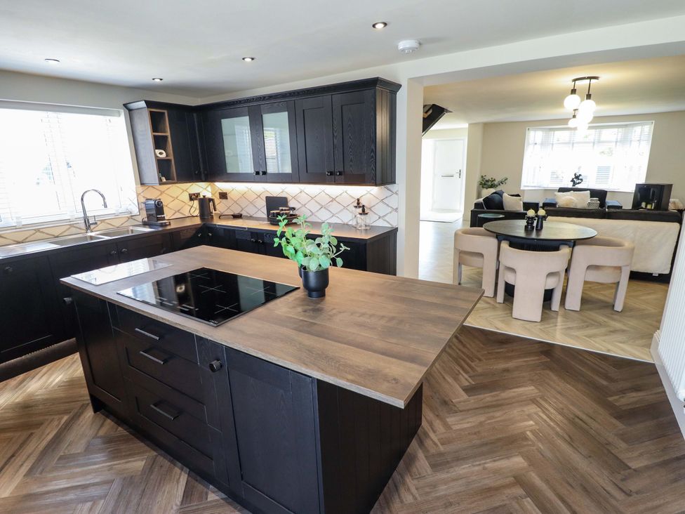 A kitchen with an island and dining area at 21 Anderby road