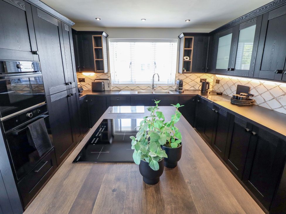 A kitchen with an island and appliances at 21 Anderby road