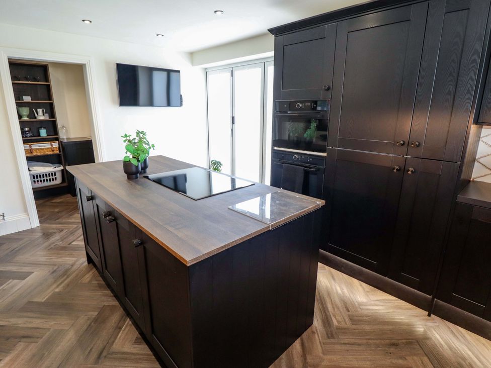 A kitchen with an island and stove at 21 Anderby road in 
