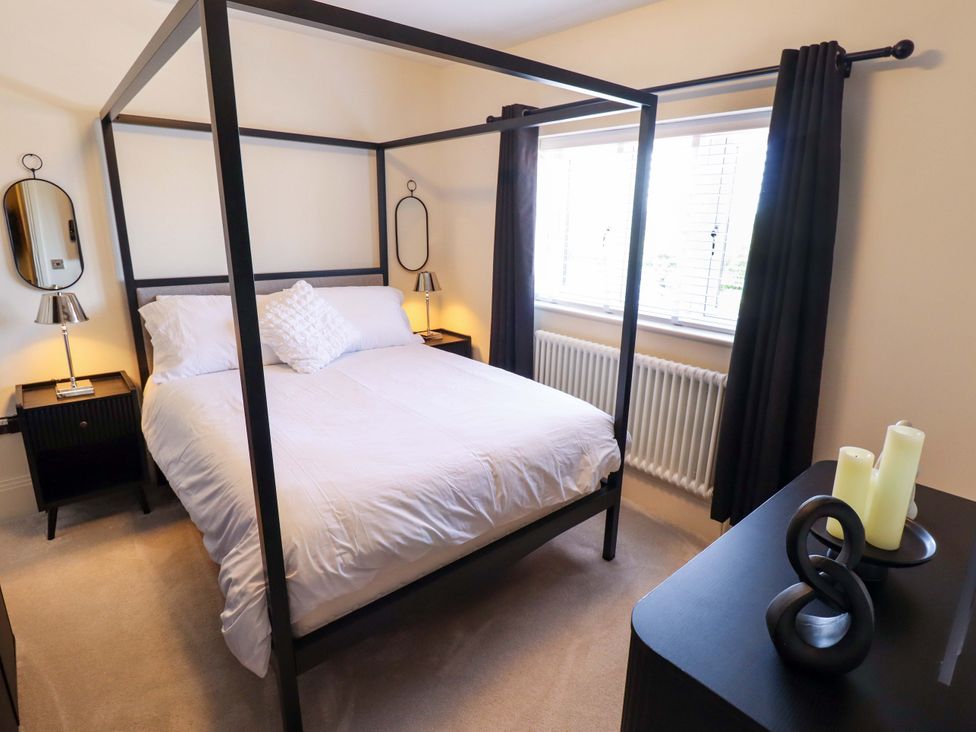 A bedroom with a canopy bed and nightstands at 21 Anderby road