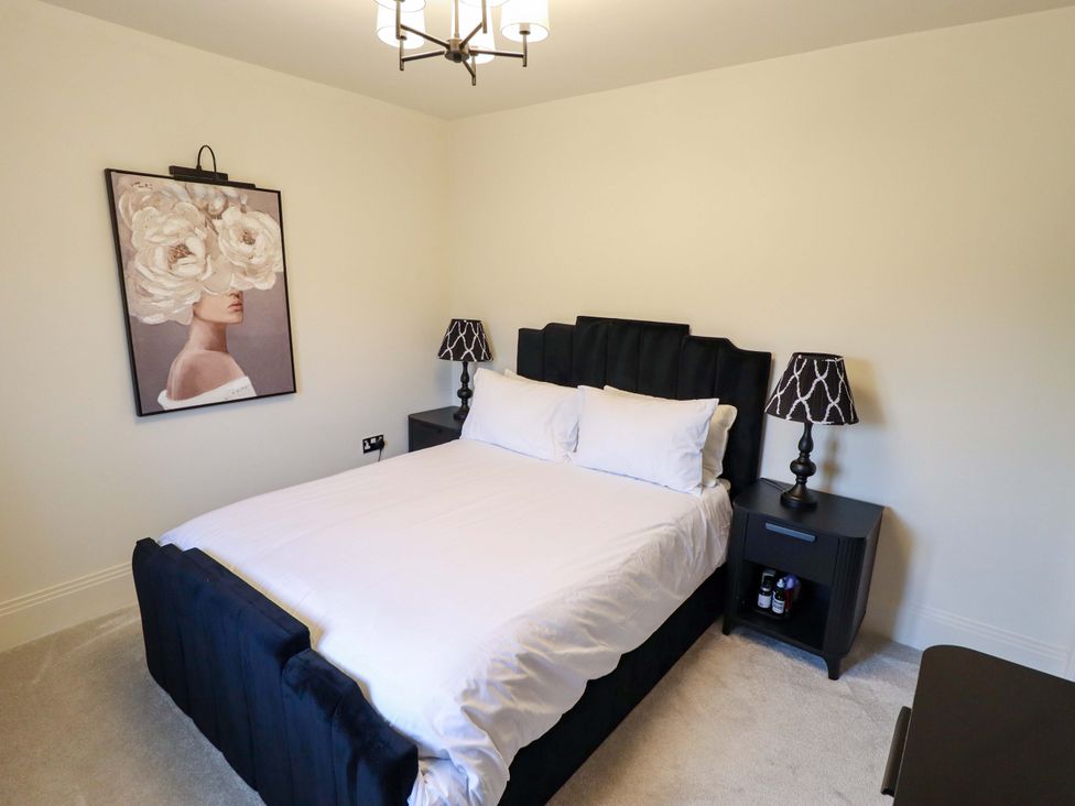 A bedroom with a bed and bedside tables at 21 Anderby road