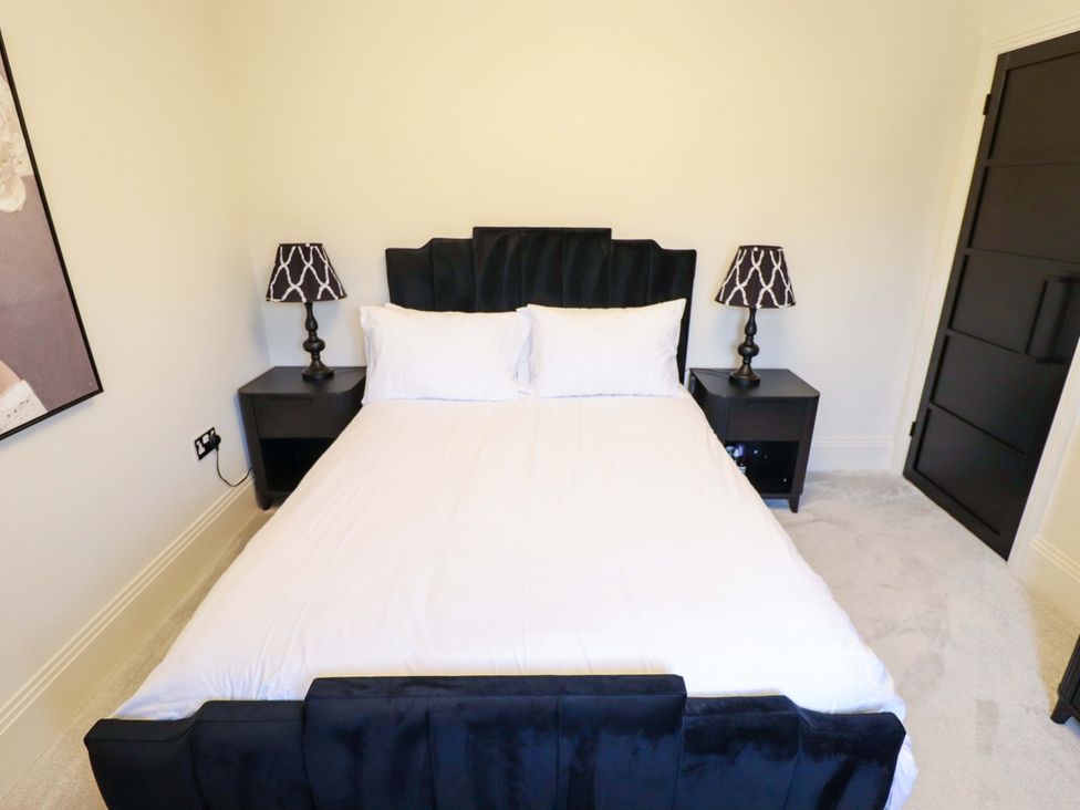 A bedroom featuring a bed and nightstands at 21 Anderby road