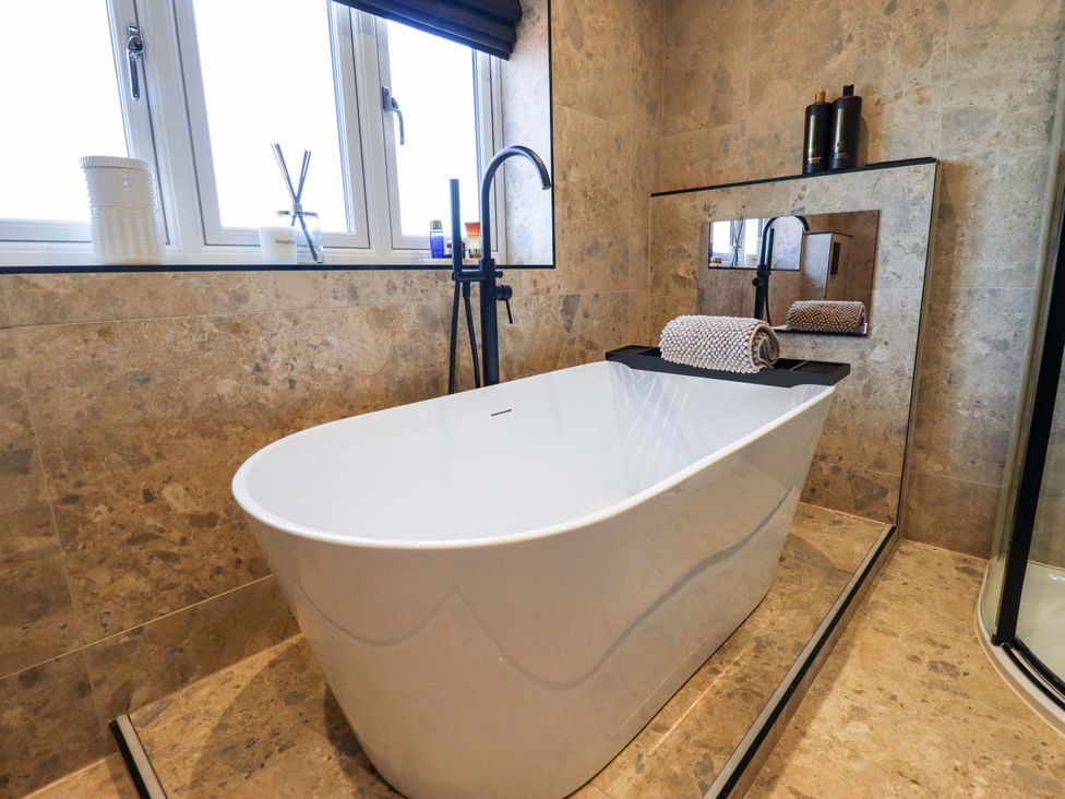 A bathroom with a bathtub and faucet at 21 Anderby road