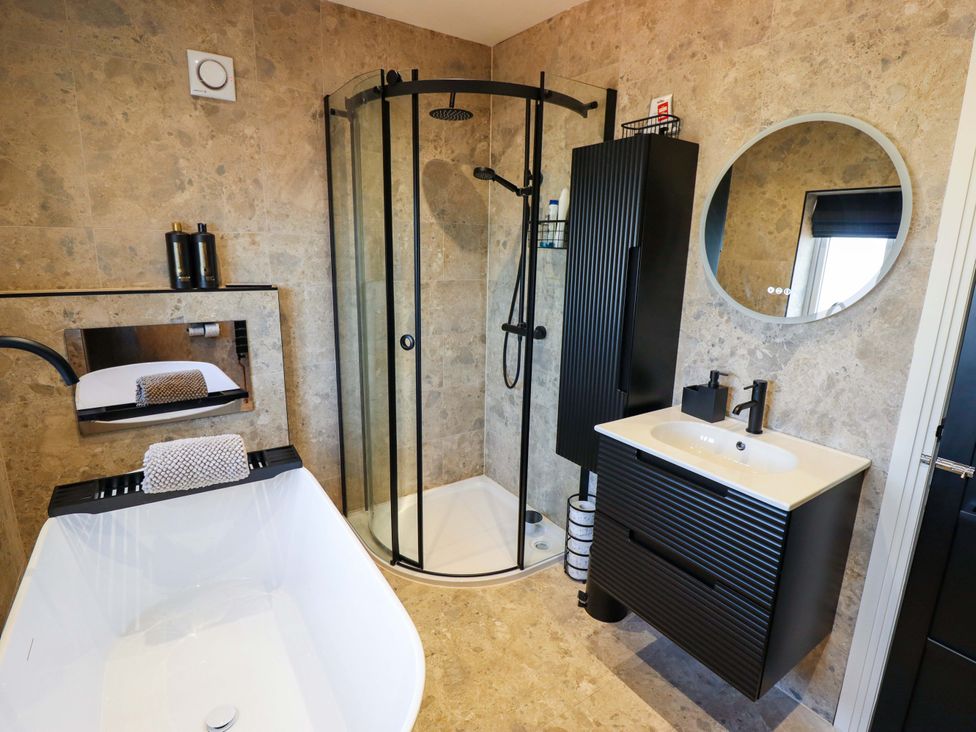 A bathroom with a bathtub and shower at 21 Anderby road
