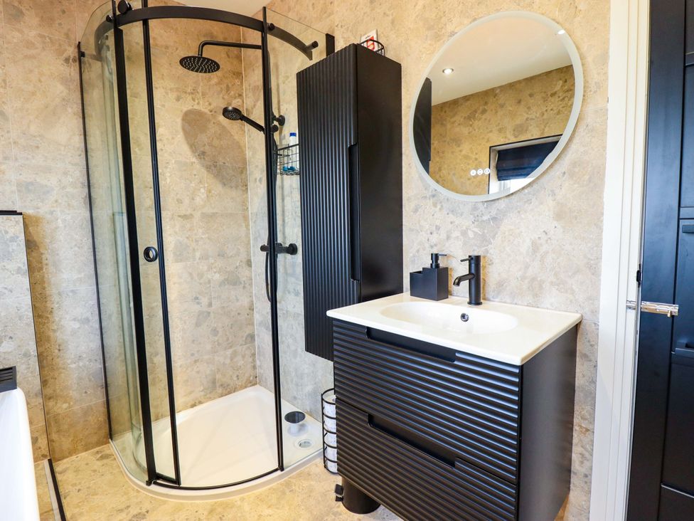 A bathroom with shower and wash basin at 21 Anderby road