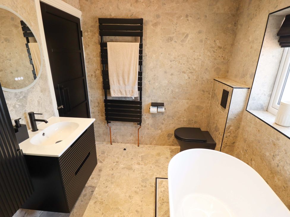 A bathroom with a bathtub, sink, and toilet at 21 Anderby road