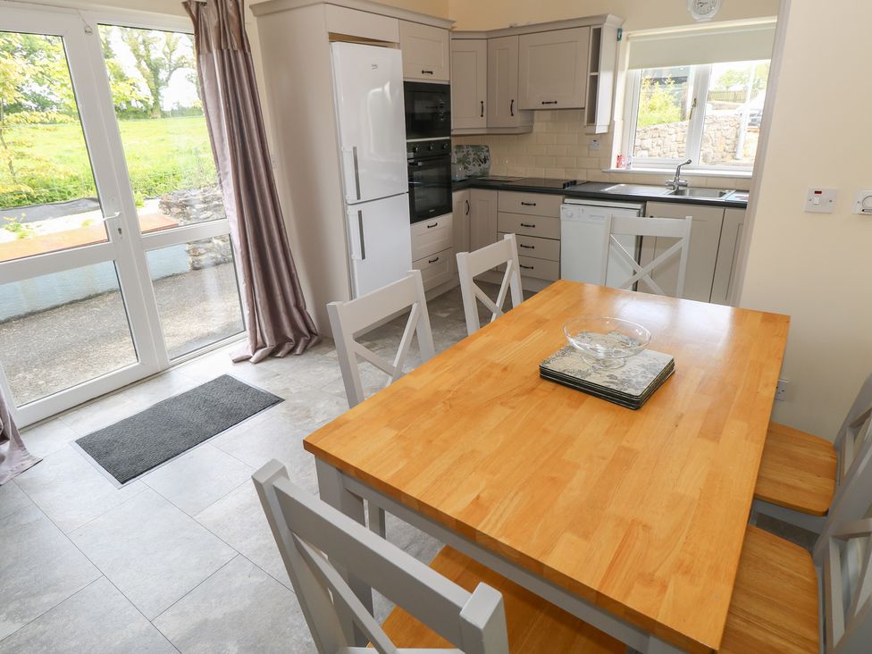 A kitchen with a dining table and chairs at River House in 