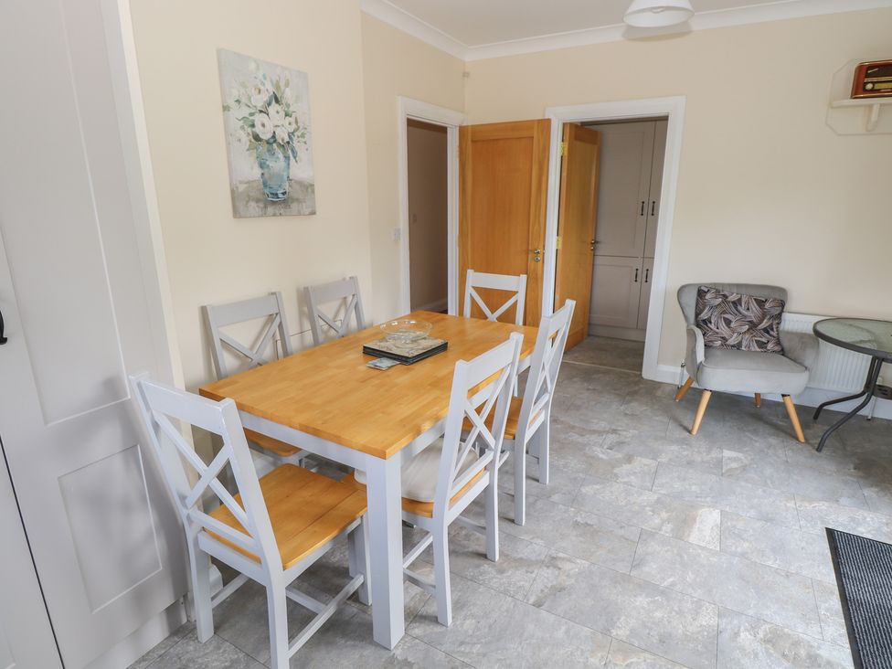 A dining room with a table and chairs at River House