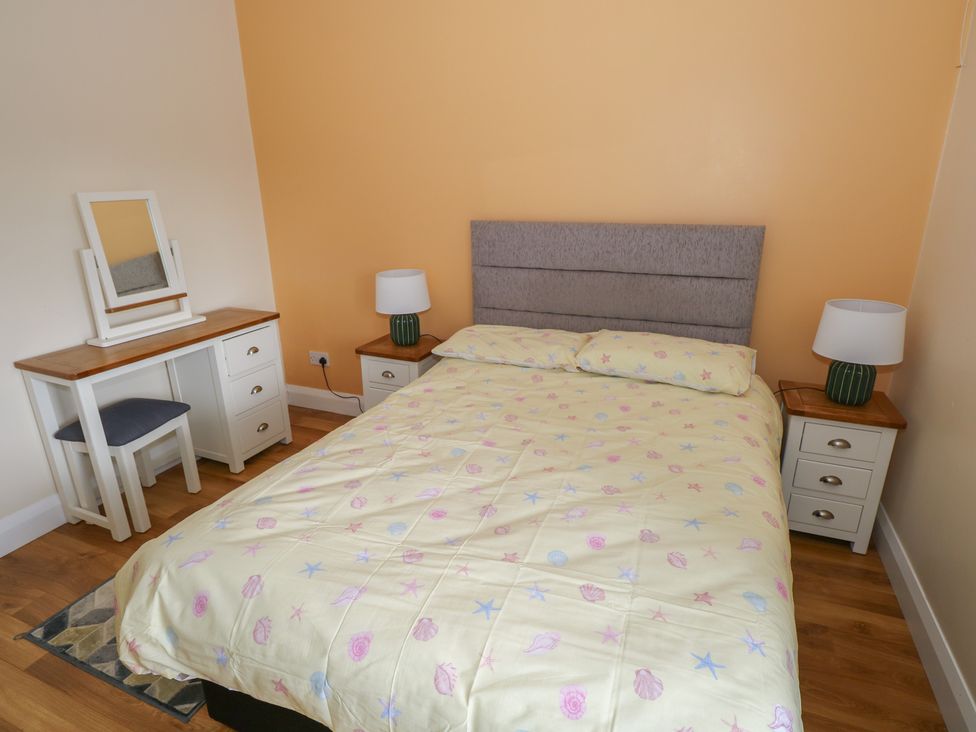 A bedroom with a bed and vanity table at River House