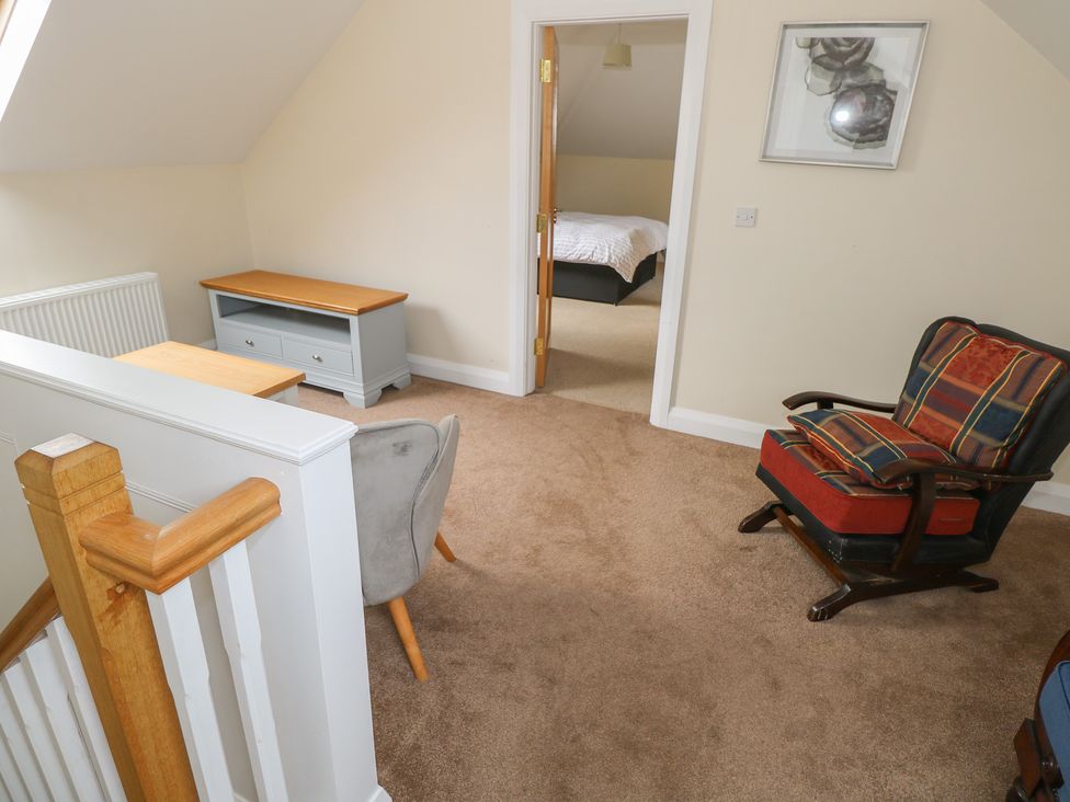 A landing with a table and armchair at River House