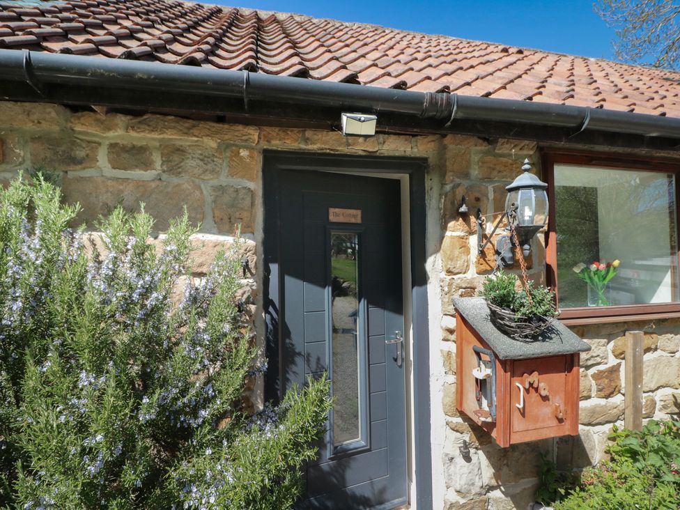 An entrance door and mailbox with plants at The Cottage in Stokesley