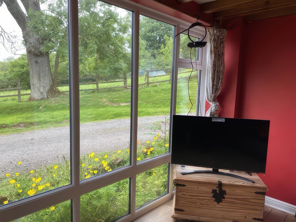 A snug with a television and a window view at The Cottage in Stokesley