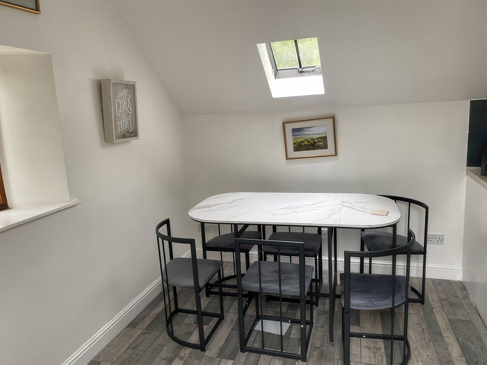 A dining room with a table and chairs at The Cottage in Stokesley