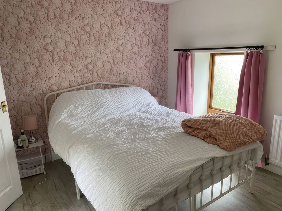 A bedroom with a bed and a window at The Cottage in Stokesley