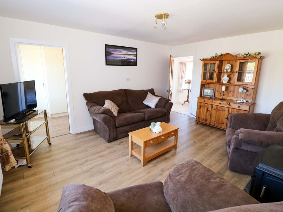 A living room with a sofa and coffee table at Cahir Cottage in Ballinrobe, County Mayo