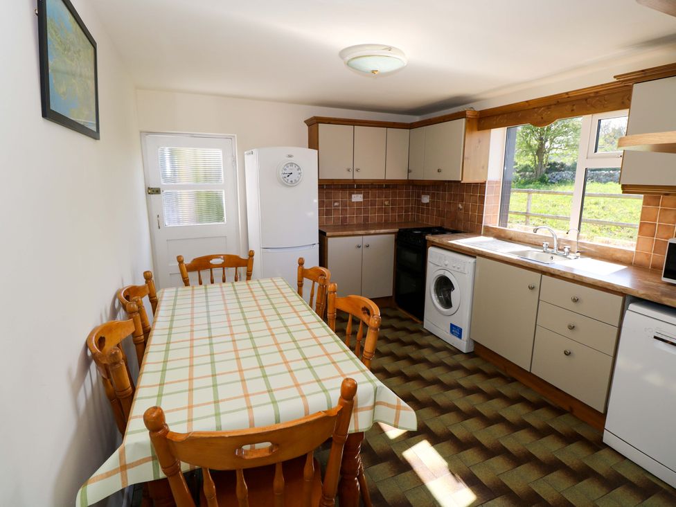 A kitchen with a dining table and chairs at Cahir Cottage in Ballinrobe, County Mayo