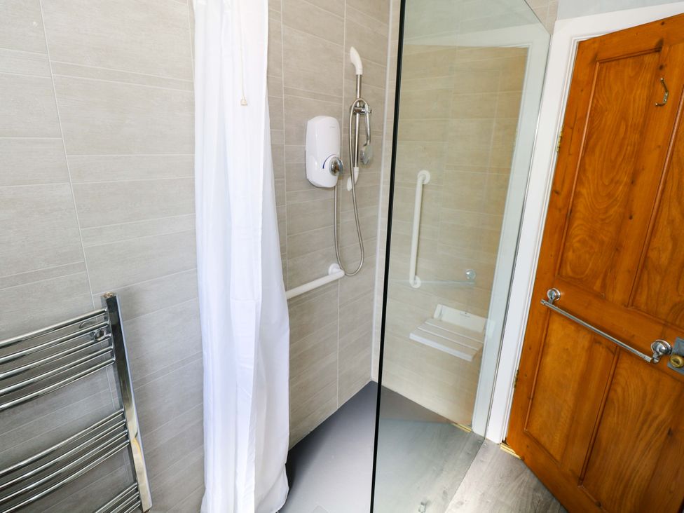 A bathroom with a shower and towel radiator at Cahir Cottage in Ballinrobe, County Mayo
