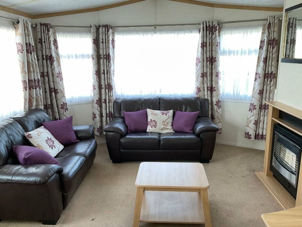 A living room with a sofa and coffee table at St Monans Holiday Park - Holiday Accommodation 19927 Anstruther
