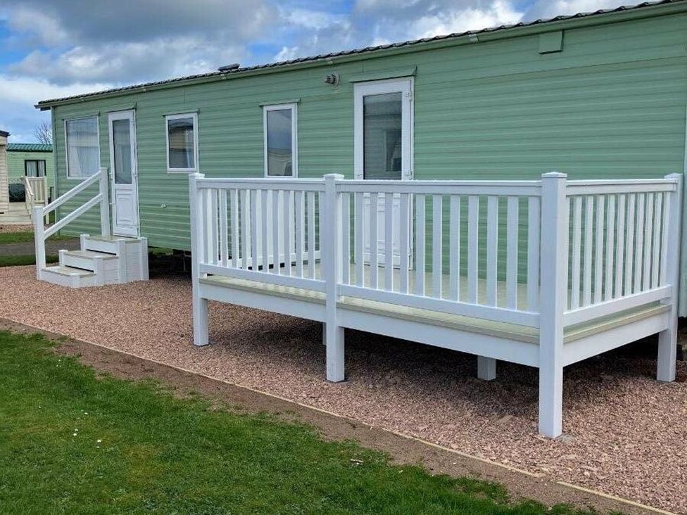 A caravan with a front deck and steps at St Monans Holiday Park - Holiday Accommodation 19927 Anstruther