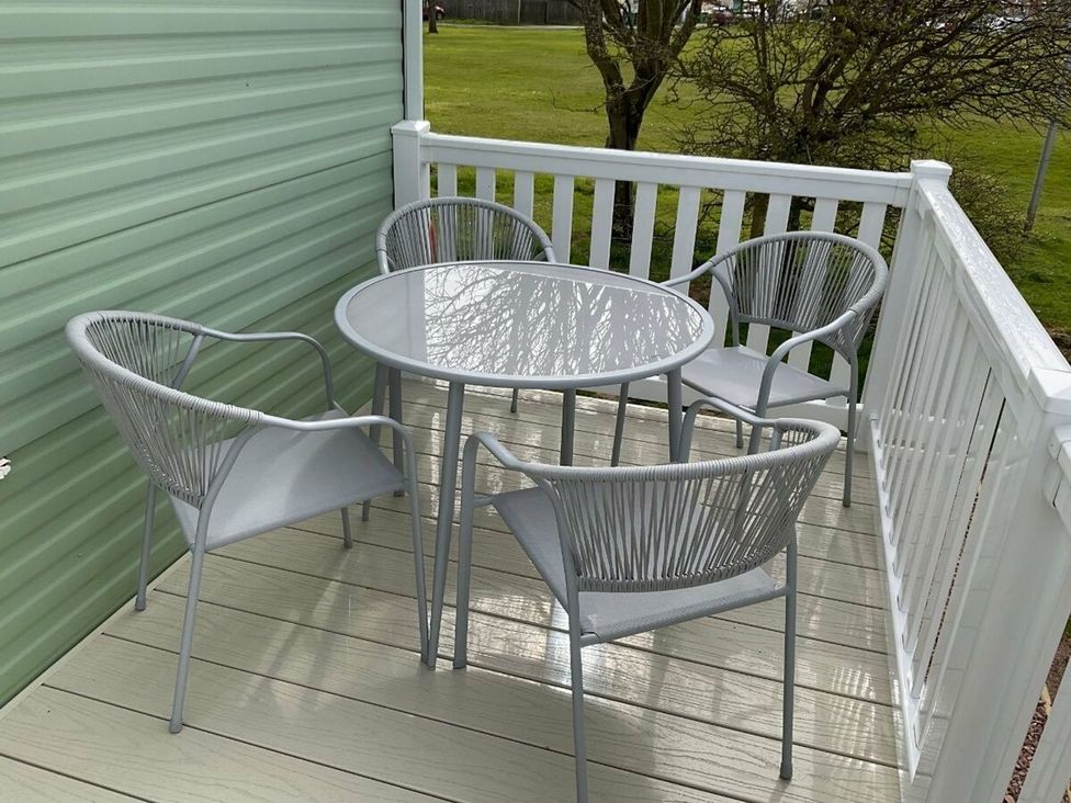 A table and chairs on a deck at St Monans Holiday Park - Holiday Accommodation 19927 in Anstruther