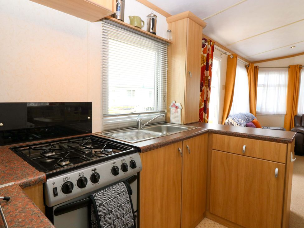A kitchen with cabinets and a gas stove at St Monans Holiday Park - Holiday Accommodation 19927 St Monans