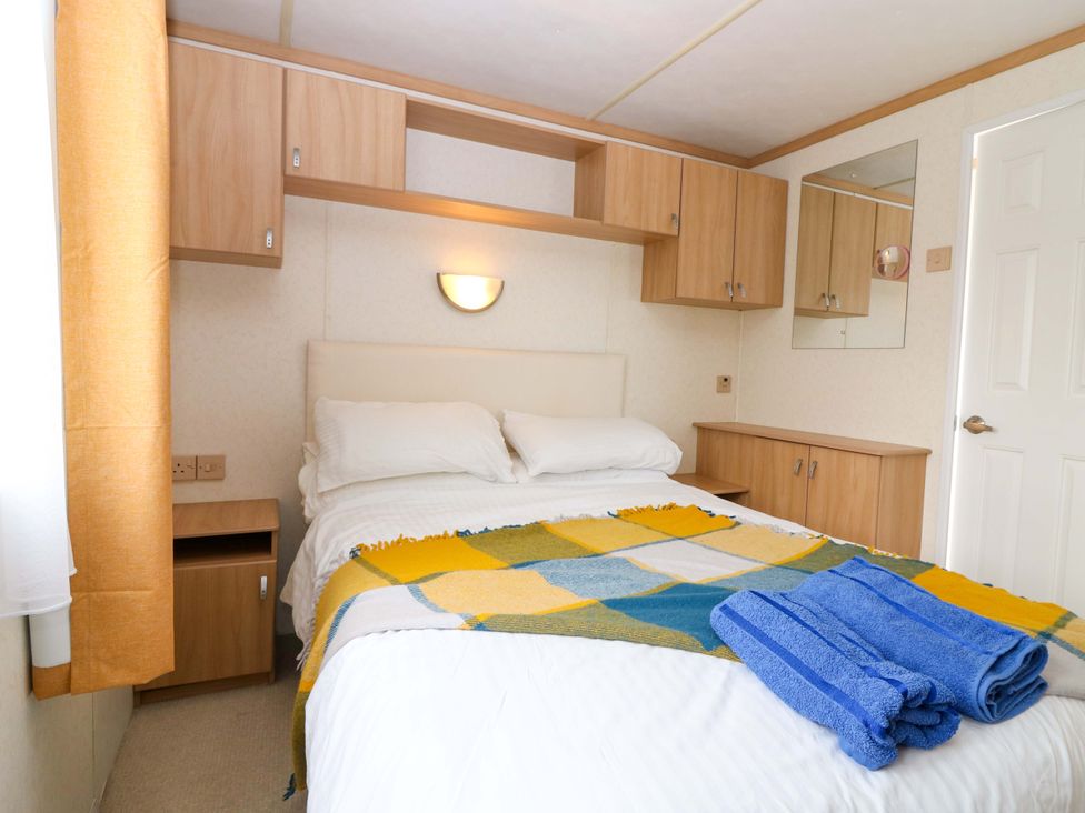 A bedroom with a bed and storage units at St Monans Holiday Park - Holiday Accommodation 19927, St Monans