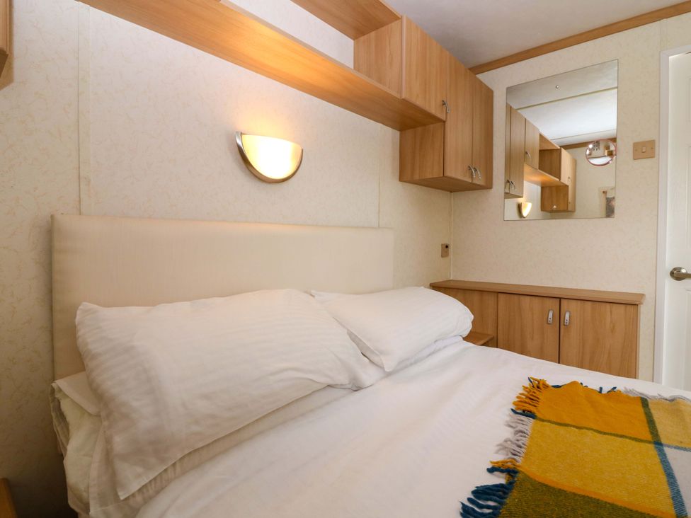 A bedroom with a bed and cabinets at St Monans Holiday Park - Holiday Accommodation 19927 St Monans