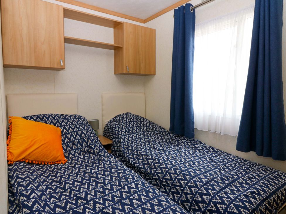 A bedroom with two single beds and a wall cupboard at St Monans Holiday Park - Holiday Accommodation 19927 St Monans