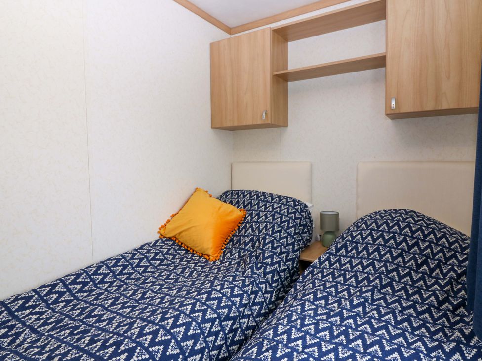 A bedroom with two single beds and a shelf at St Monans Holiday Park - Holiday Accommodation 19927 St Monans