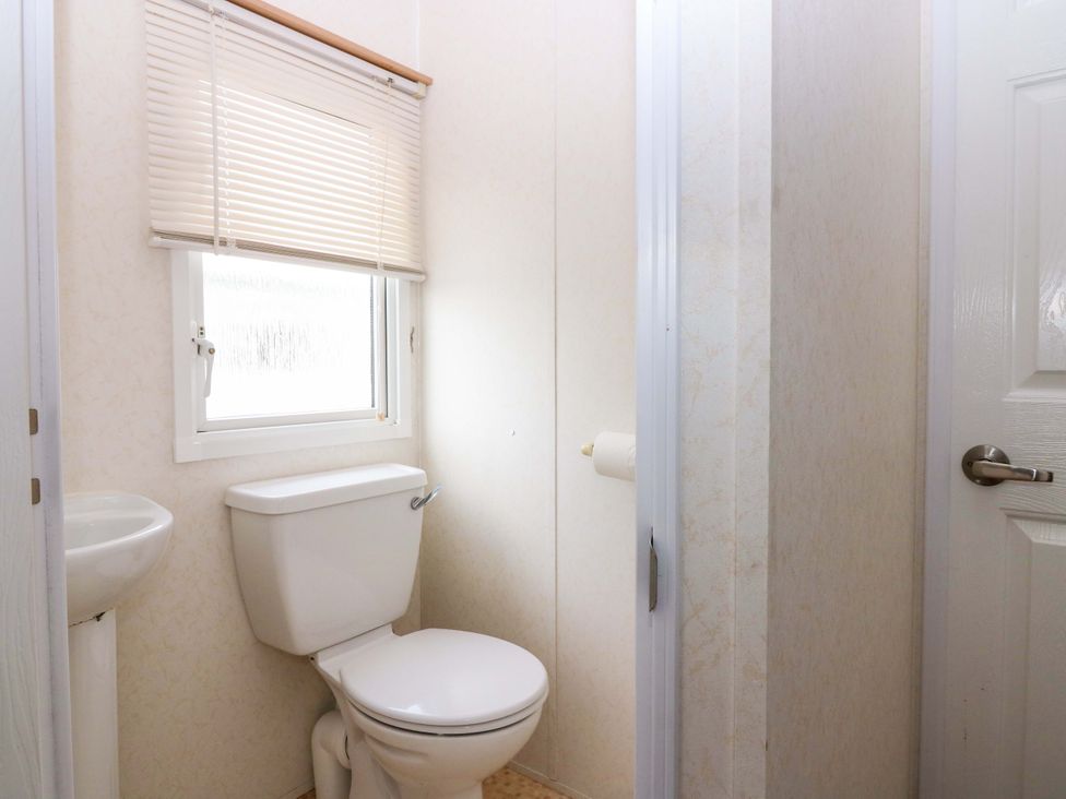 A bathroom with a toilet and sink at St Monans Holiday Park - Holiday Accommodation 19927, St Monans