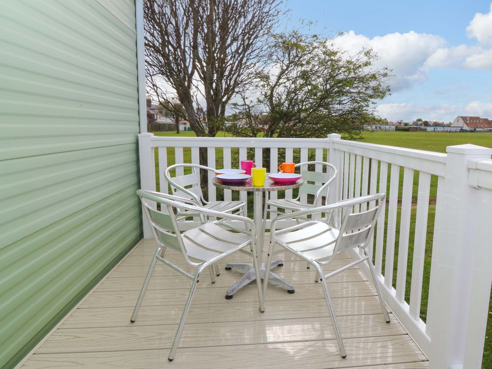 A balcony with a table and chairs at St Monans Holiday Park - Holiday Accommodation 19927, St Monans