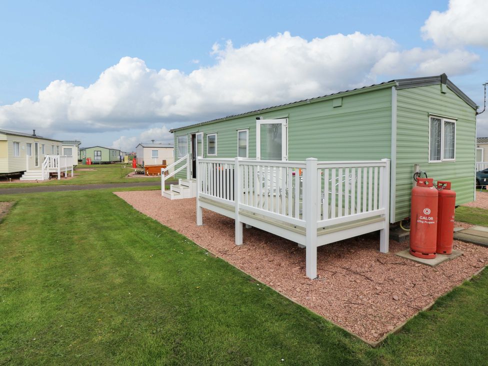 A caravan with a deck and gas cylinders at St Monans Holiday Park - Holiday Accommodation 19927, St Monans