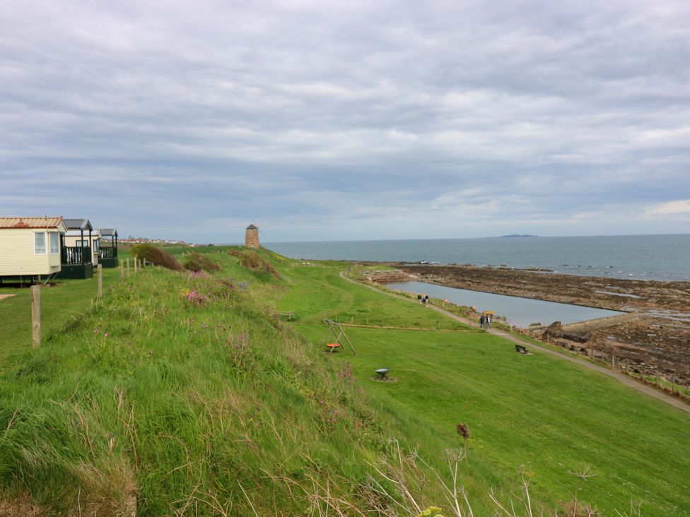 A coastal view with caravans and people at St Monans Holiday Park - Holiday Accommodation 19927, St Monans