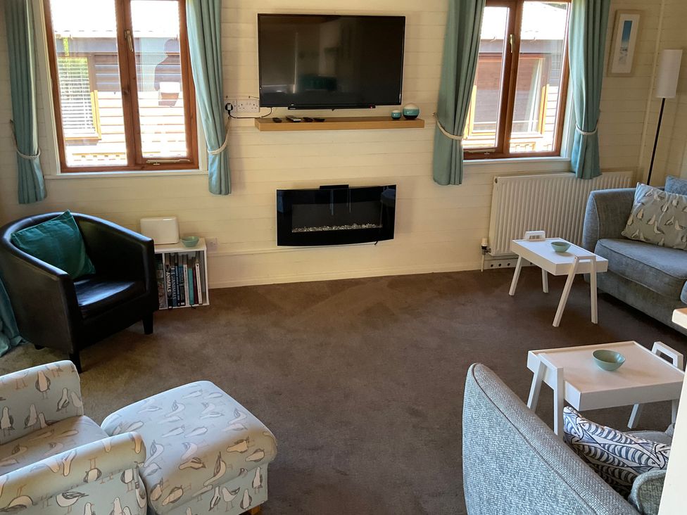 A living room with a sofa and fireplace at Lodge 37 in Ilfracombe