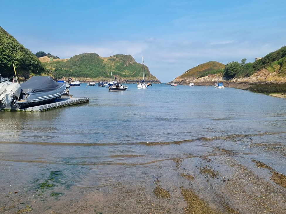 A view of boats in water with hills in the background at Lodge 37 in Ilfracombe