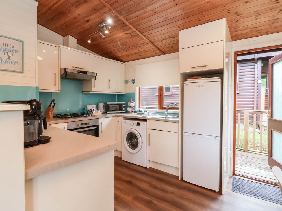 A kitchen with appliances and countertop at Seagull Lodge Watermouth near Combe Martin