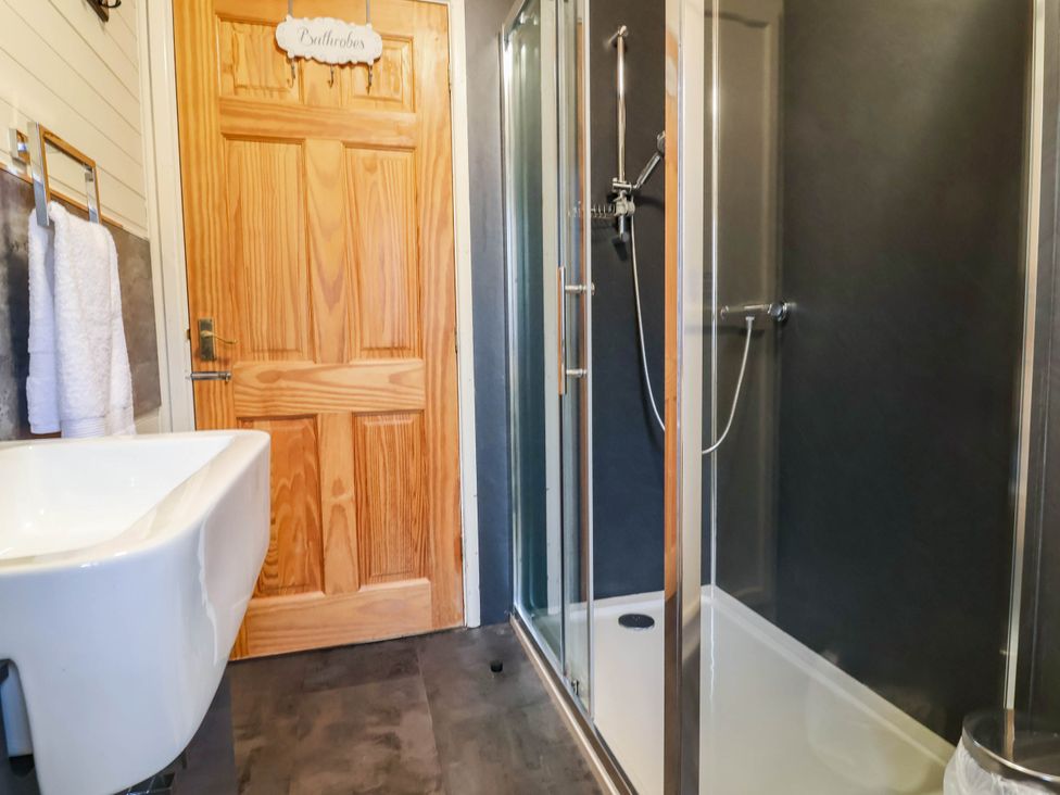 A bathroom with a sink and shower at Seagull Lodge Watermouth near Combe Martin