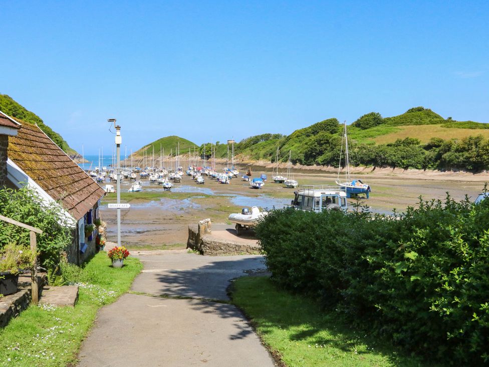 A view of boats on water with hills in the background at Seagull Lodge Watermouth near Combe Martin