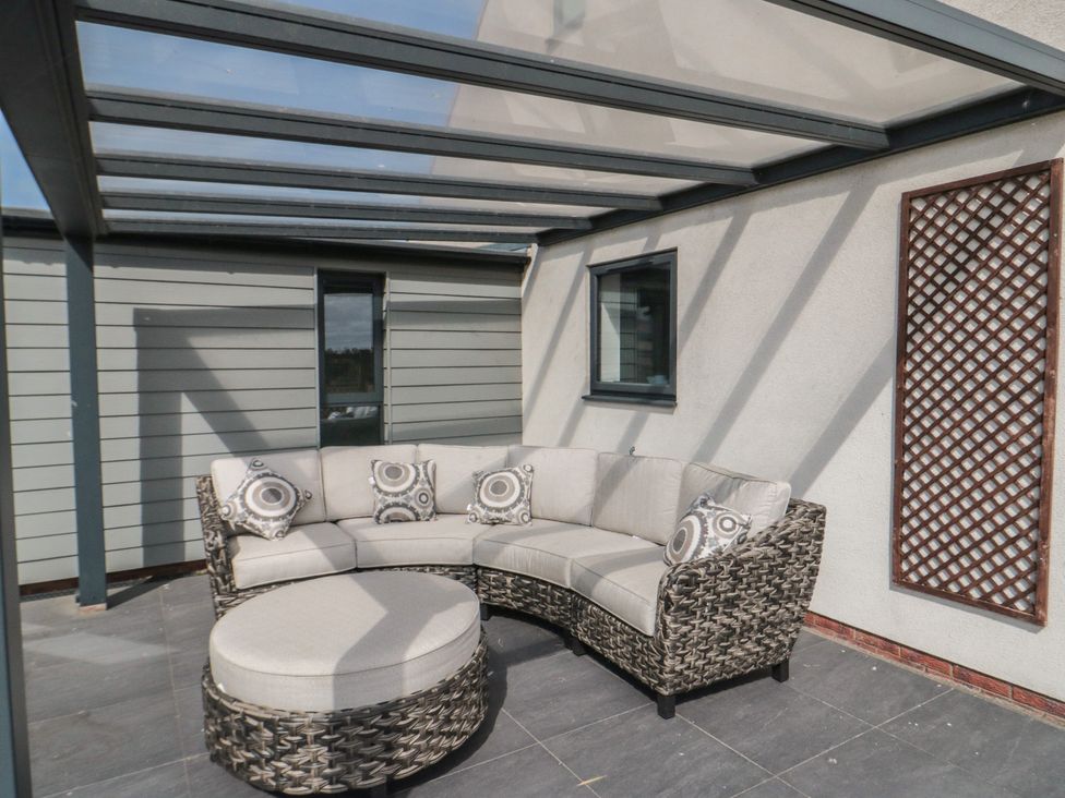 An outdoor seating area with a sofa and ottoman at Bay View