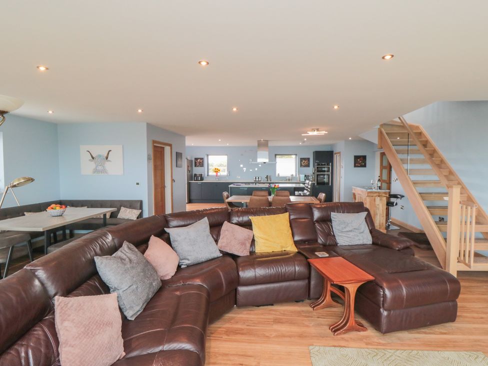 A living room with a sofa and dining table at Bay View
