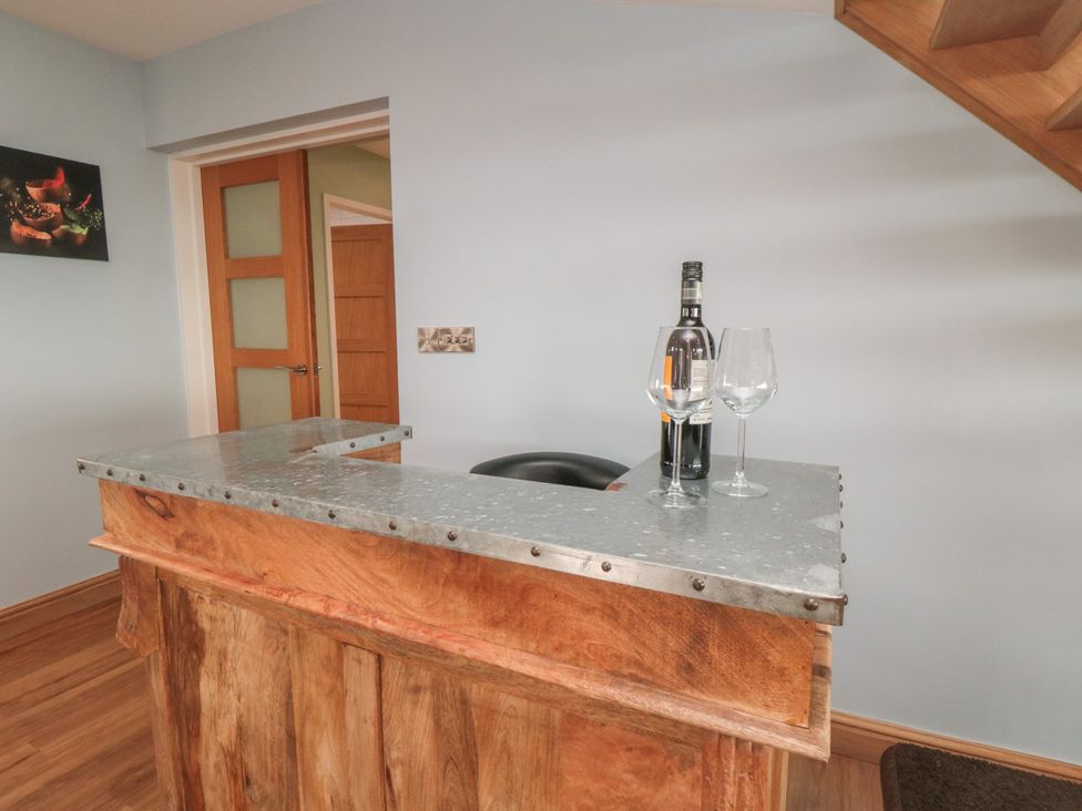 A bar area with a counter, wine bottle, and glasses at Bay View