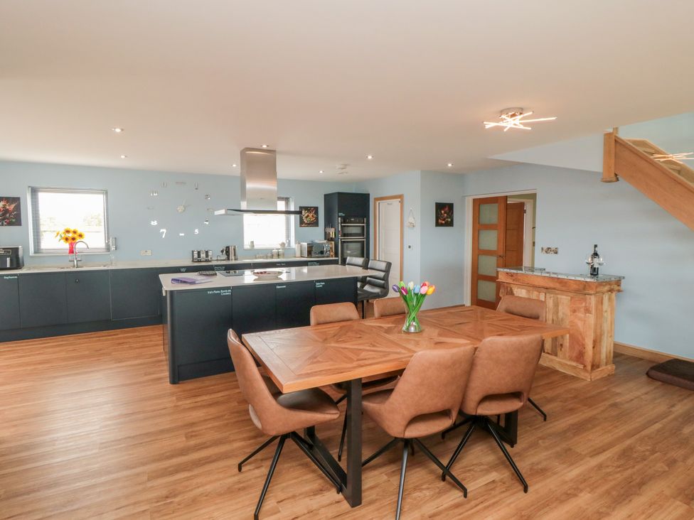 A kitchen with dining area and modern appliances at Bay View 