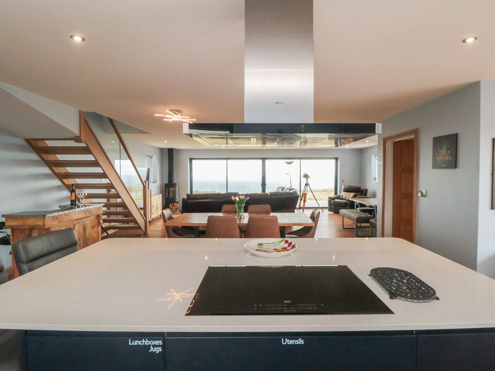 A kitchen with a cooking surface and staircase at Bay View